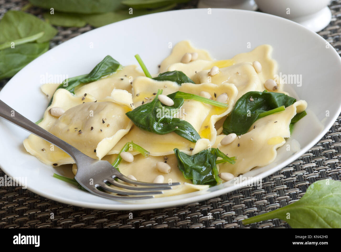 Ricotta and herb ravioli with spinach and pine nuts Stock Photo Alamy