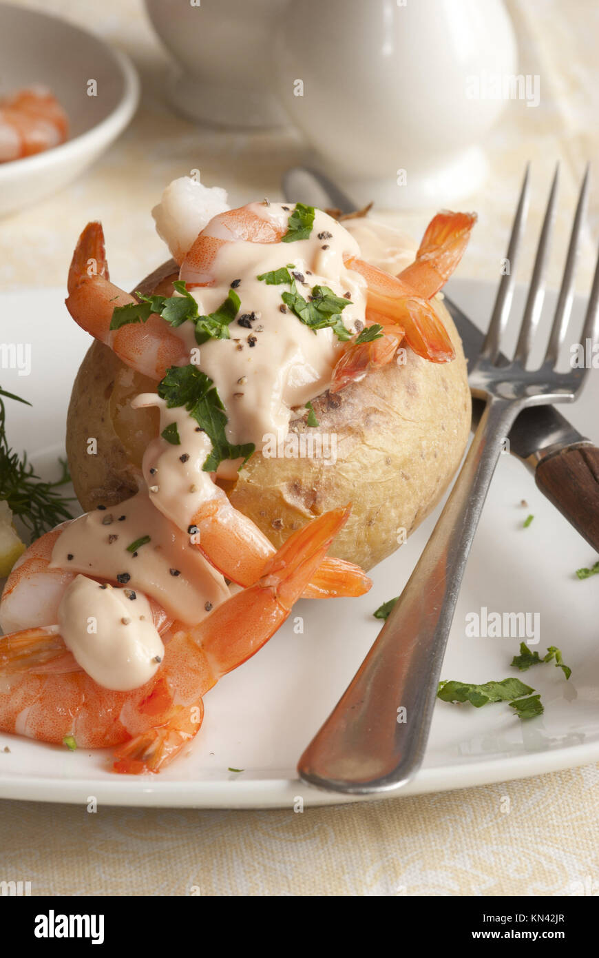 Jacket potato filled with prawn cocktail and herbs Stock Photo Alamy