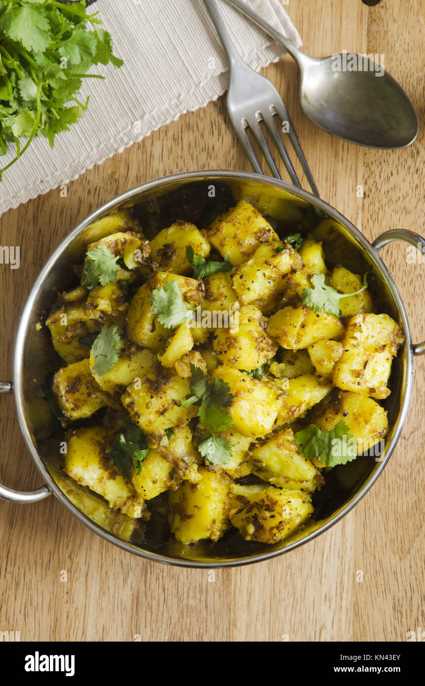 Indian spiced potato curry topped with coriander Stock Photo Alamy