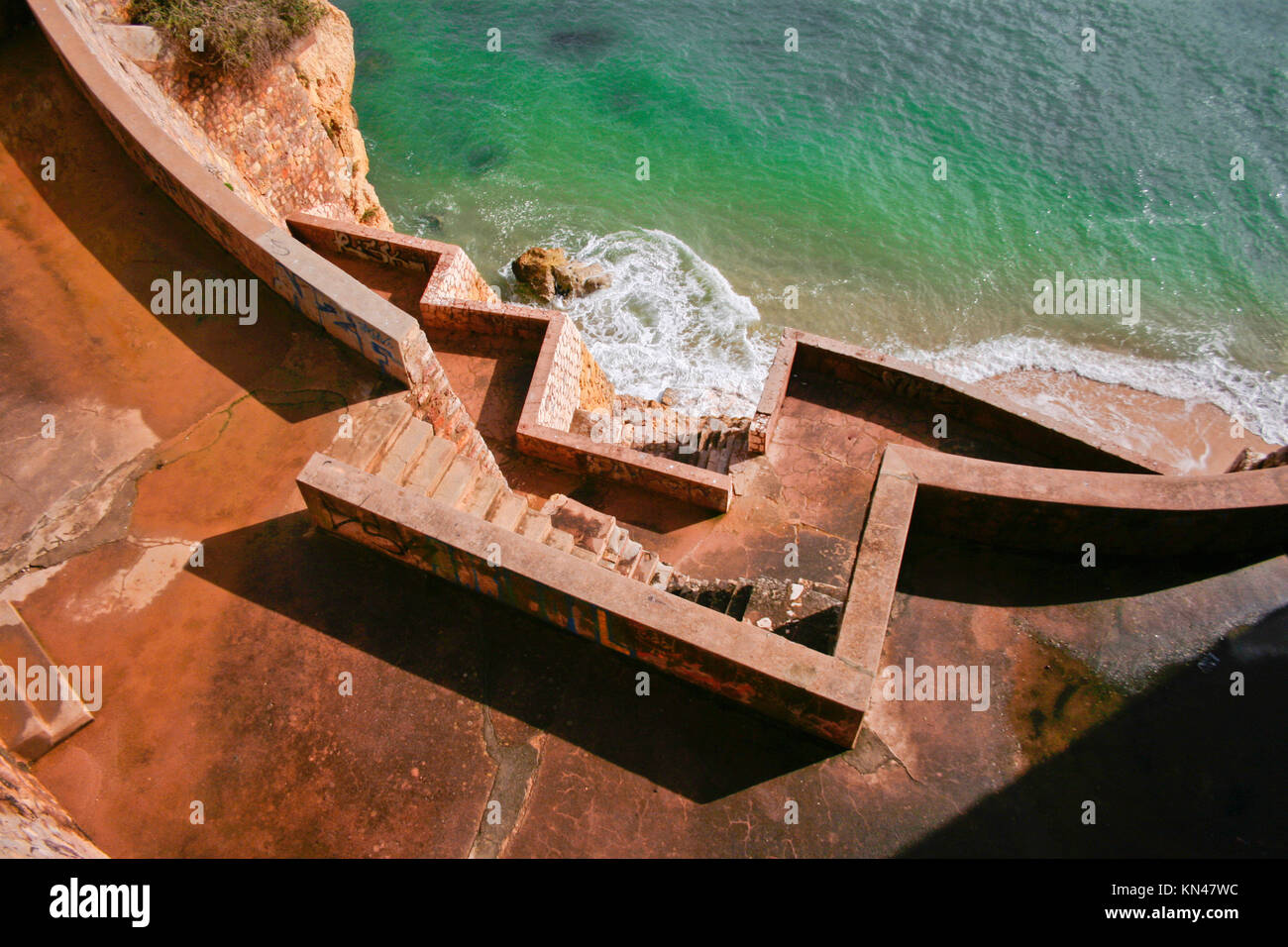 Concrete stairs going down until the seashore, Lagos, Portugal. Stock Photo