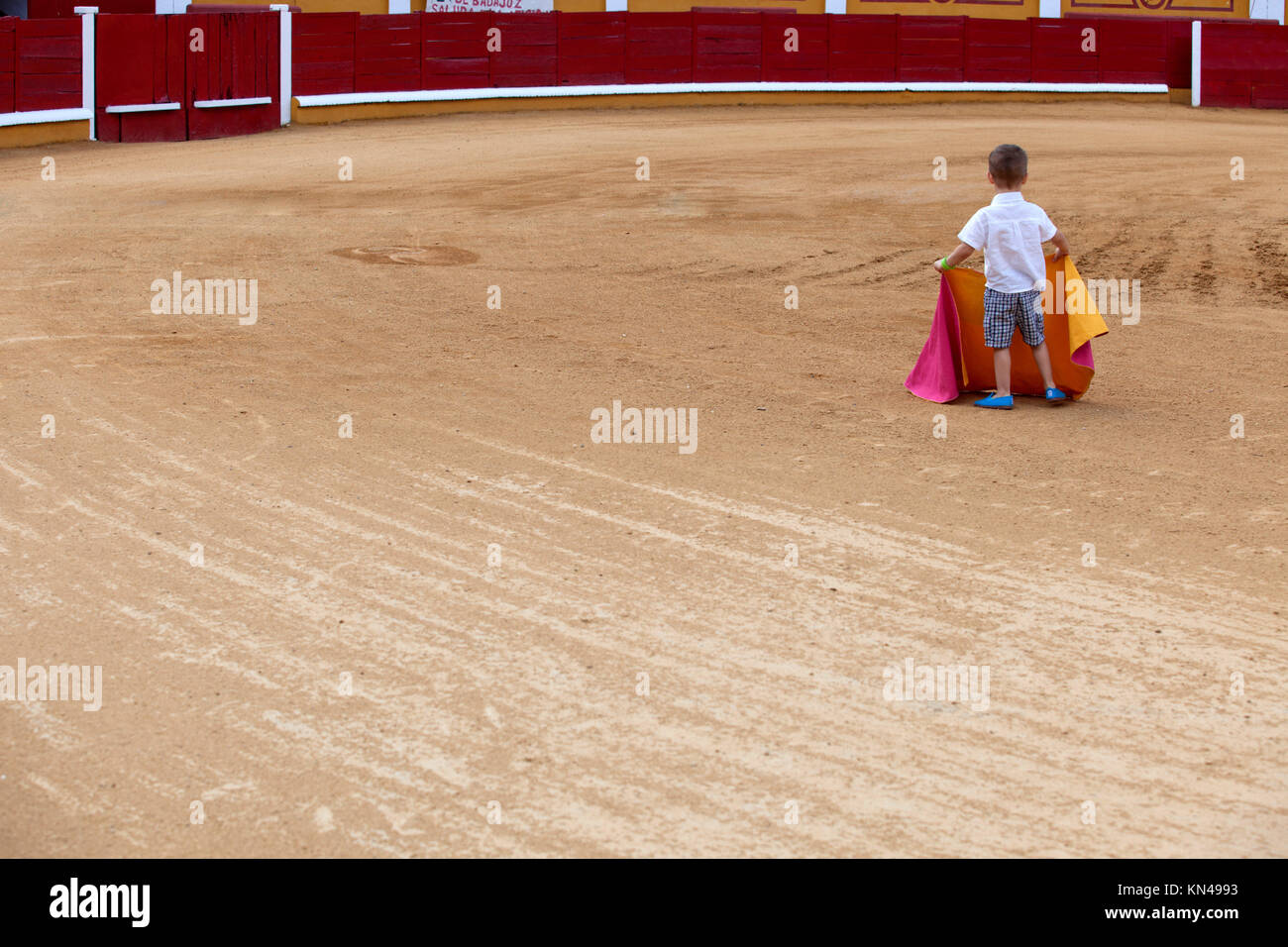 Unidentified child on arena pretending performs a bullfight, Badajoz, Spain. Stock Photo