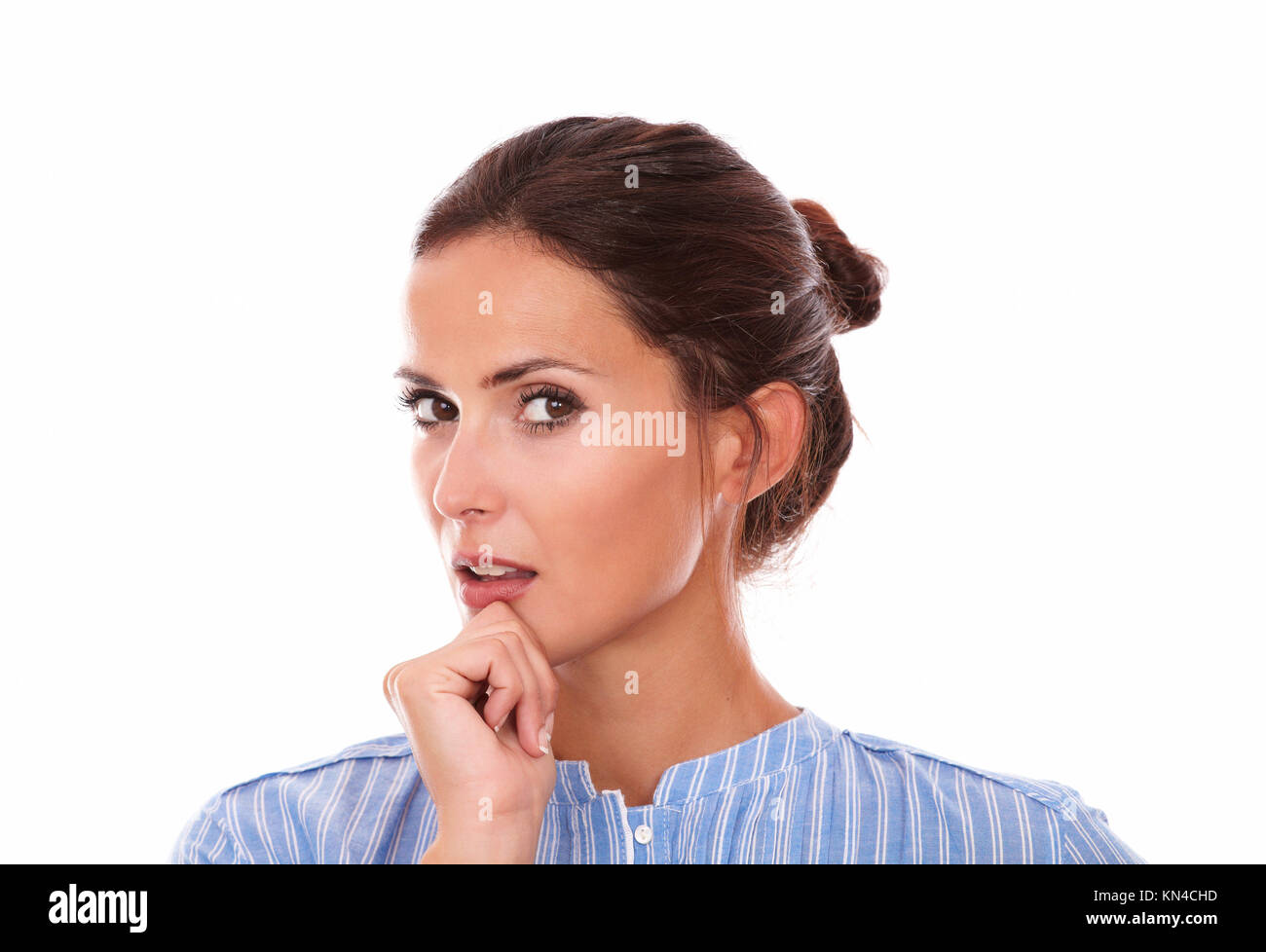 Closeup portrait of 30-34 years brunette on blue shirt wondering and looking at you on isolated white background. Stock Photo