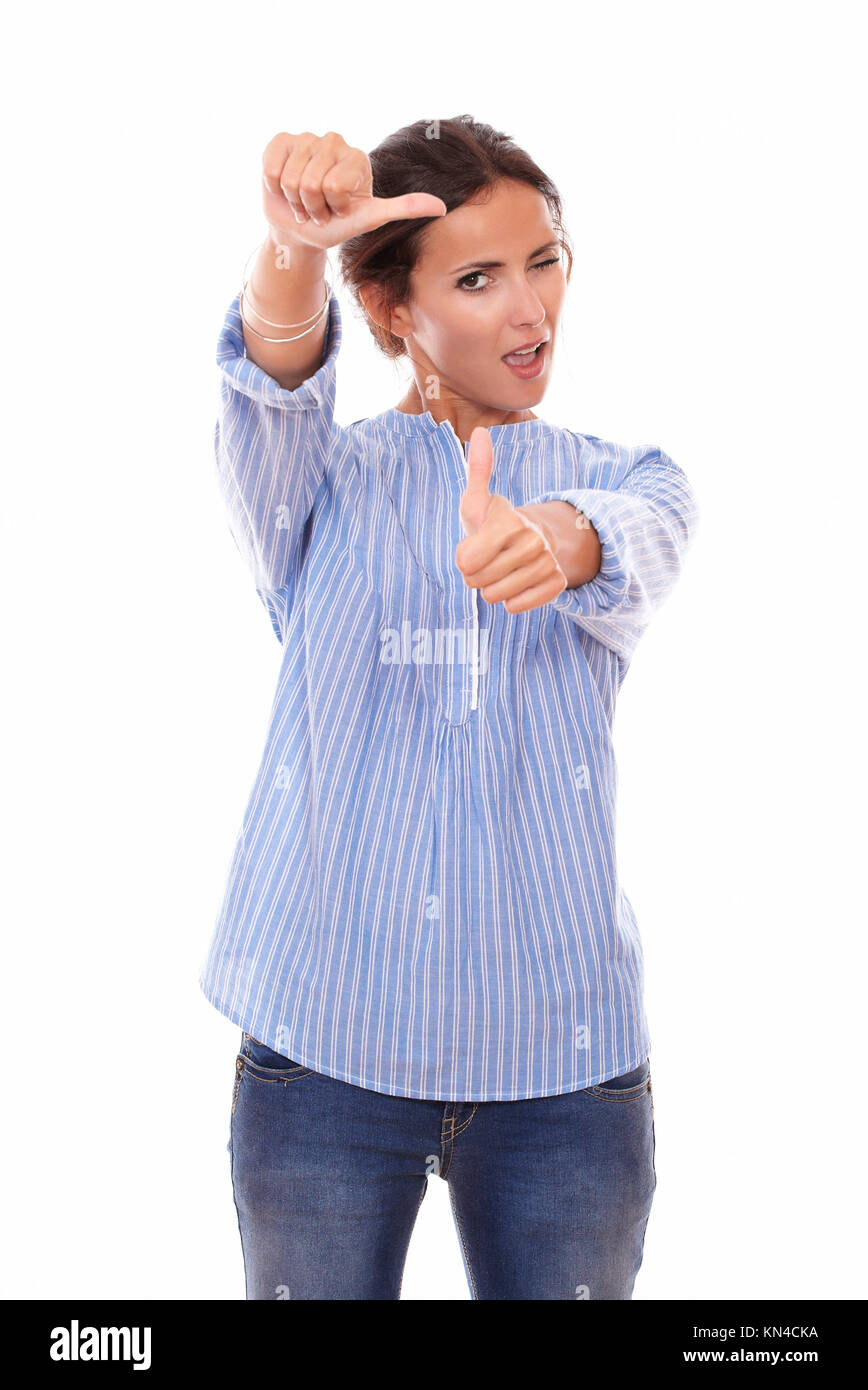 Portrait of beautiful adult woman with great job gesture looking at you while standing on isolated studio. Stock Photo