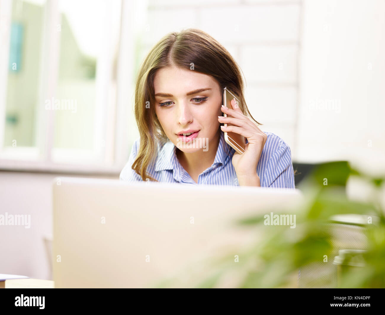 beautiful young caucasian businesswoman talking on mobile phone. Stock Photo