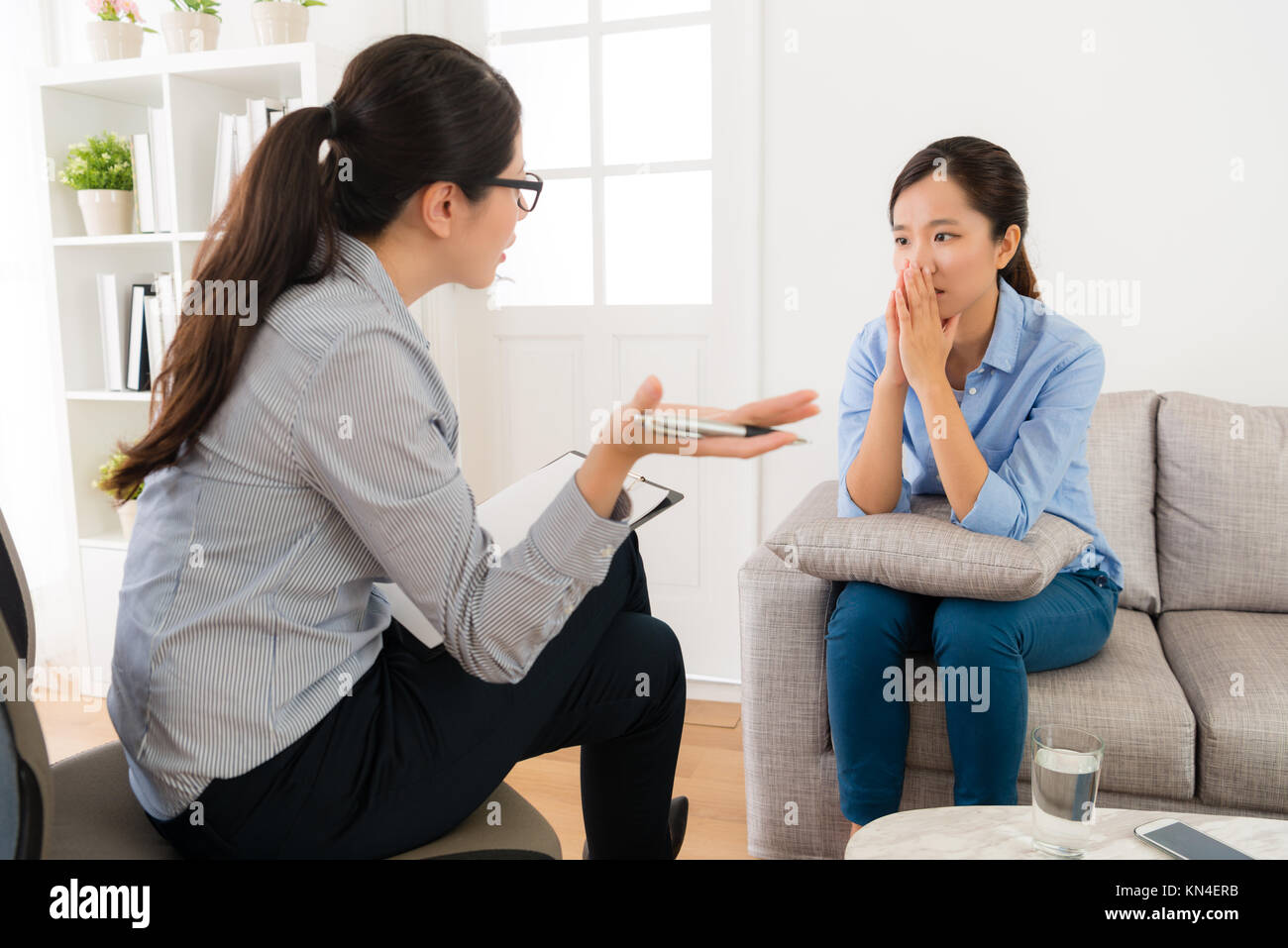 professional young female psychologist doctor talking with her patient