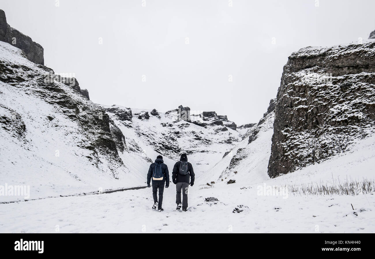 People walking at the Winnats Pass in Peak District National Park, as heavy snowfall across parts of the UK is causing widespread disruption, closing roads and grounding flights at an airport. Stock Photo