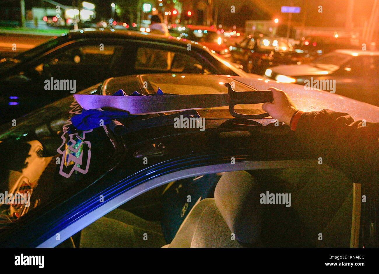 Suffolk County Police officers from the antigang unit show a machette