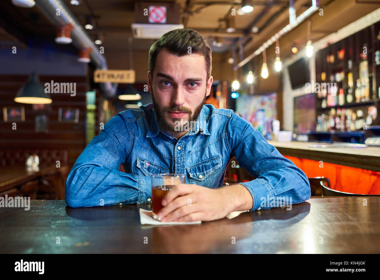 Drunk Young Man in Pub Stock Photo