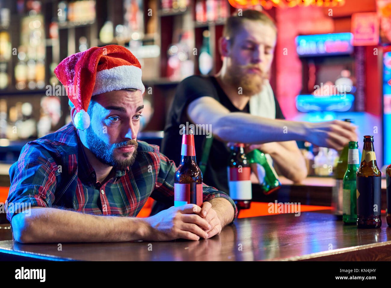Drunk Man in Pub on Christmas Stock Photo