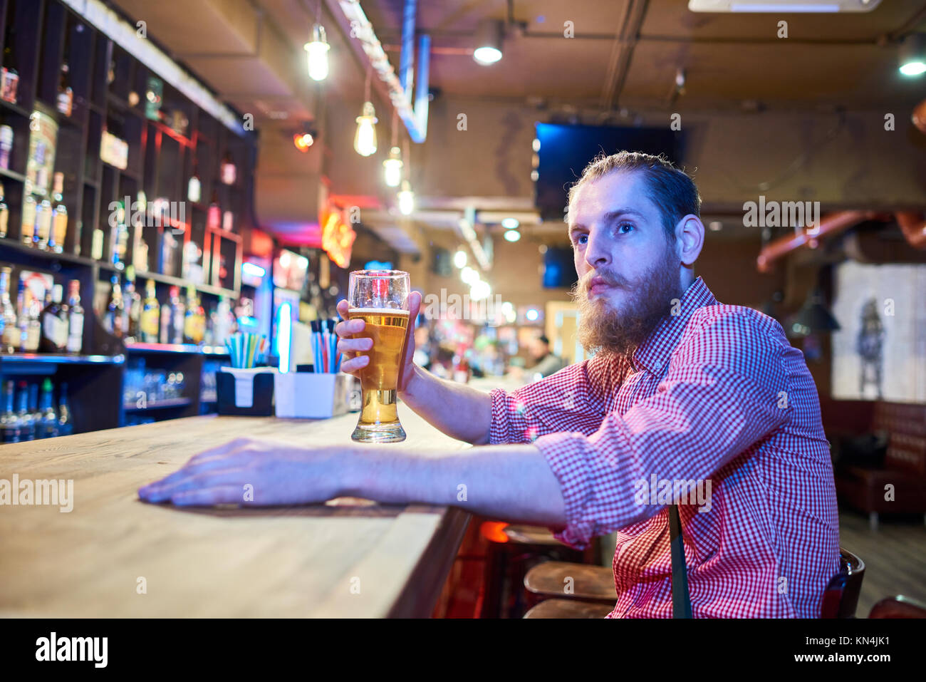 Contemporary  Young Man Chilling in Bar Stock Photo