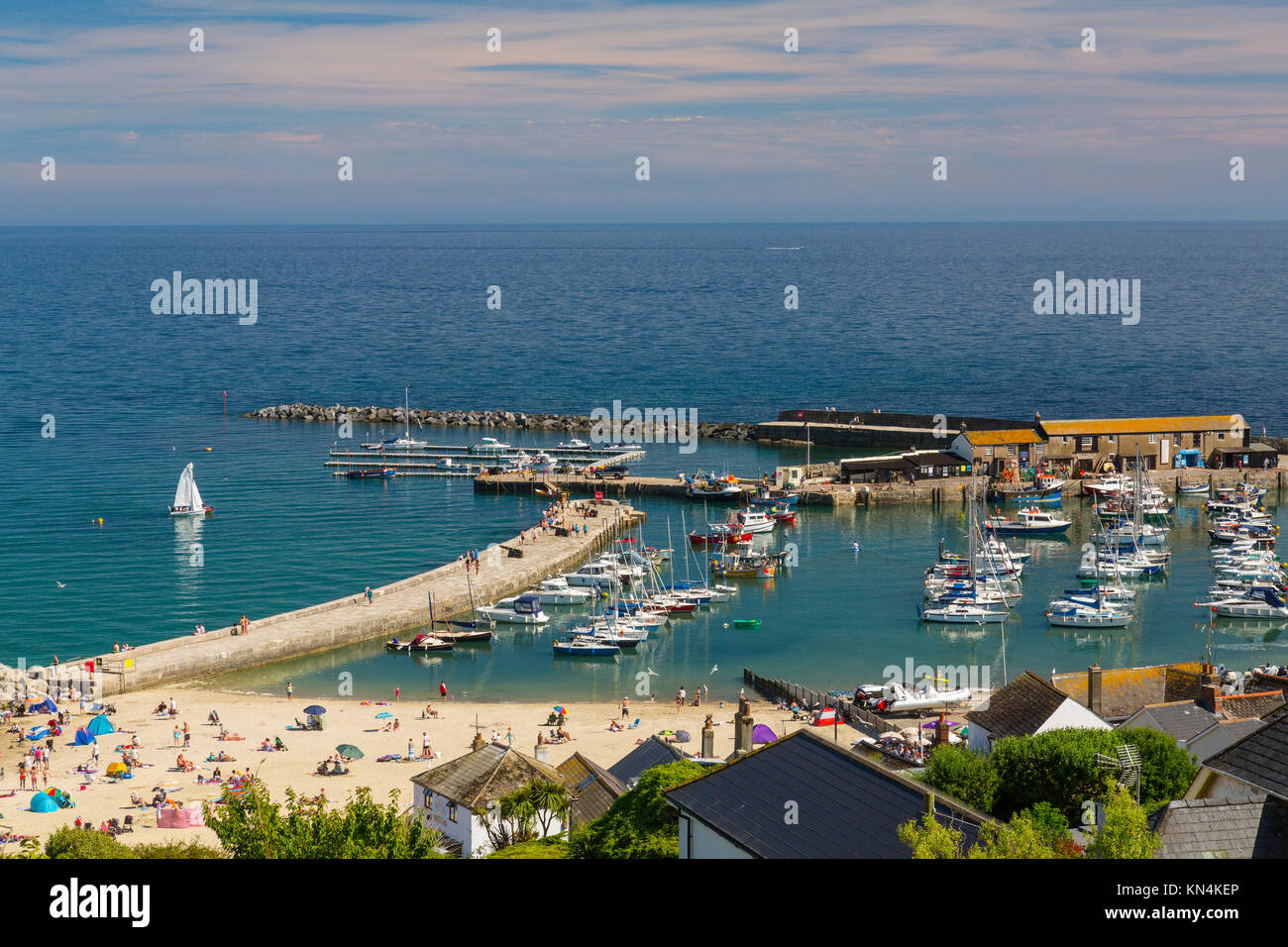 High tide and colourful boats in the harbour at Lyme Regis on the