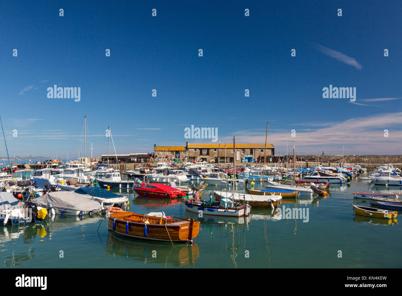 High tide and colourful boats in the harbour at Lyme Regis on the