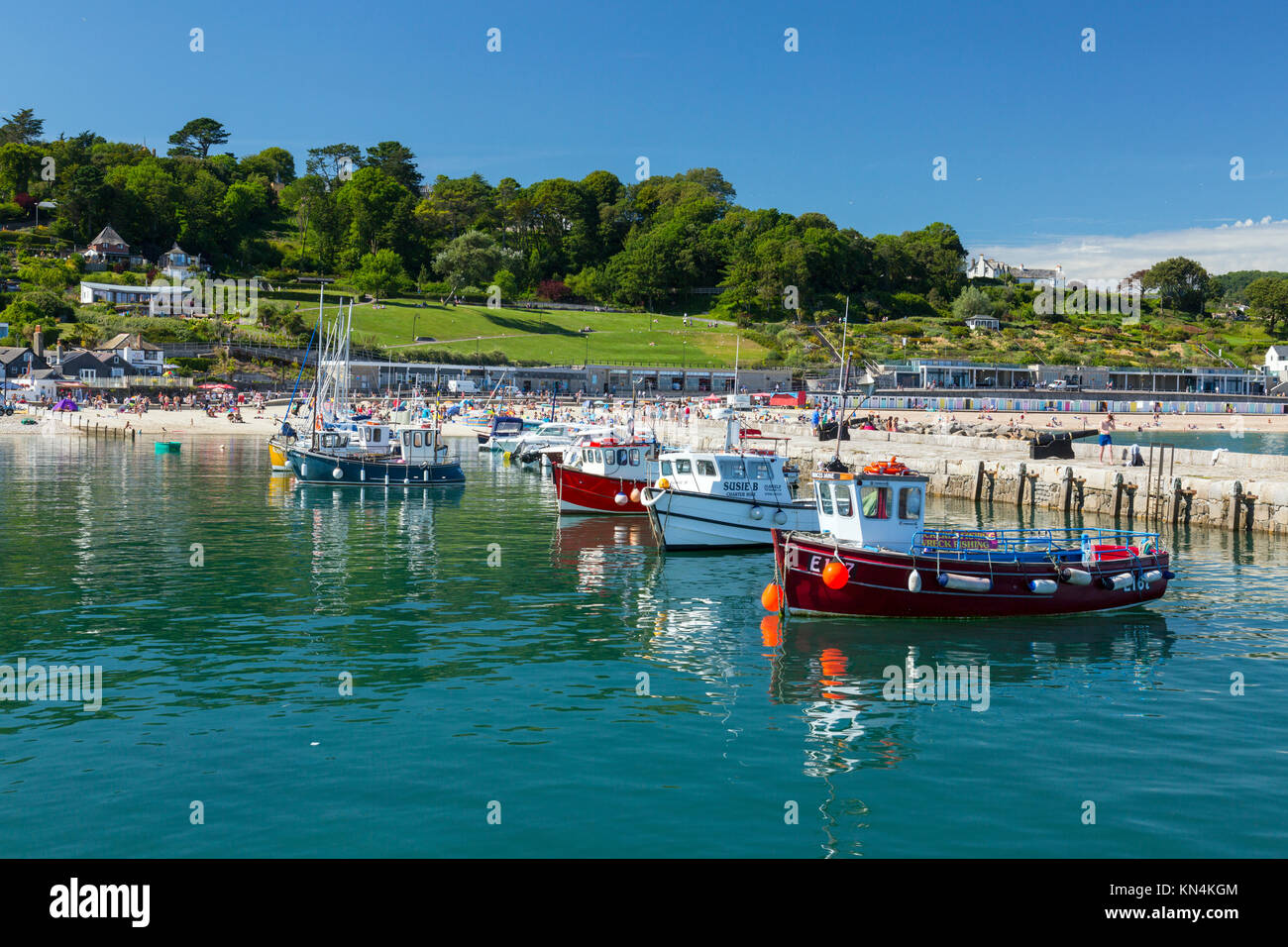 High tide and colourful boats in the harbour at Lyme Regis on the