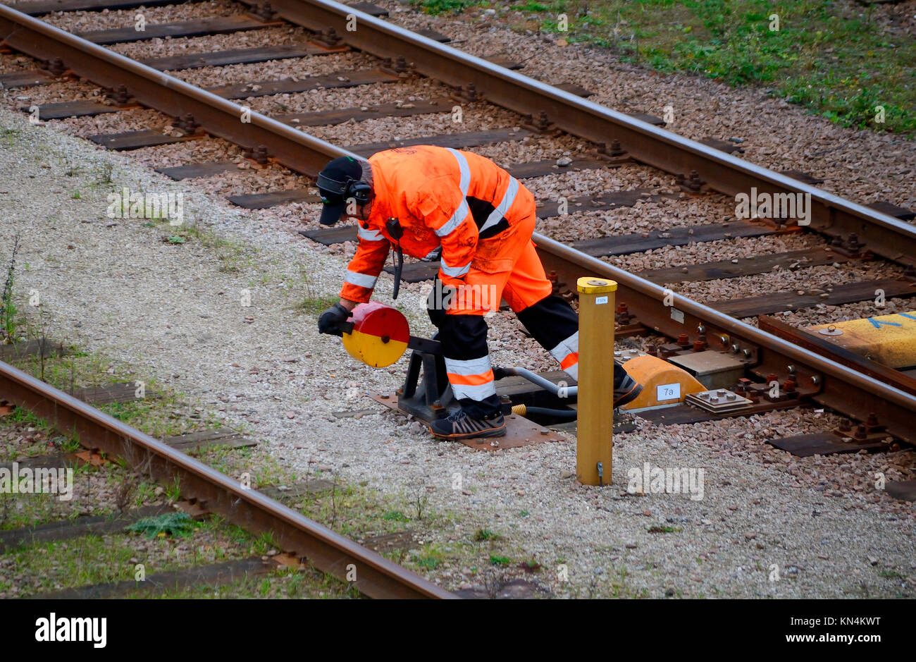 Railway worker shunt a switch on railway station, Ystad, Scania, Sweden Stock Photo