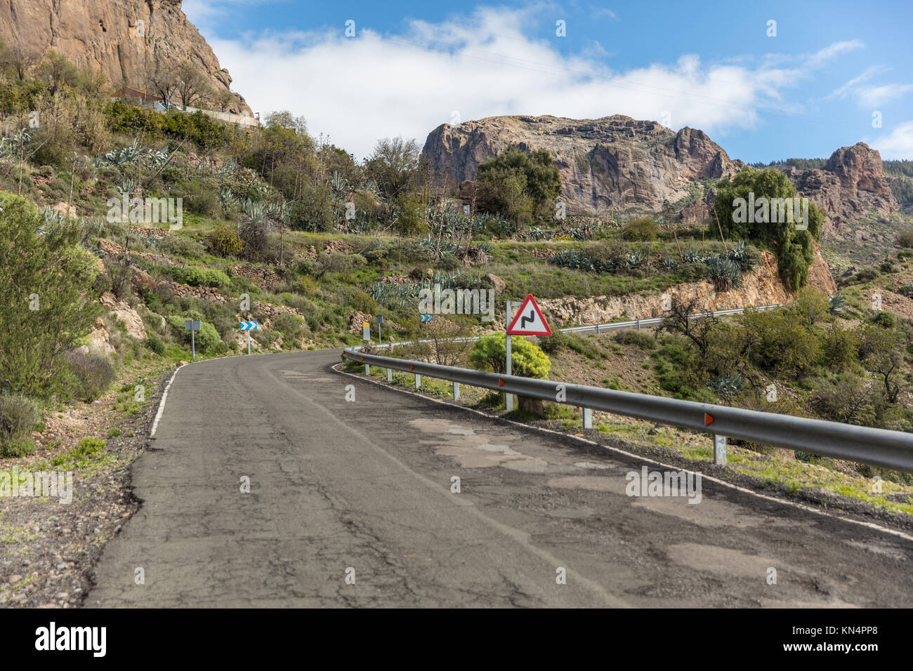 Street or roadway with curve in Gran Canaria with double curve road sign Stock Photo