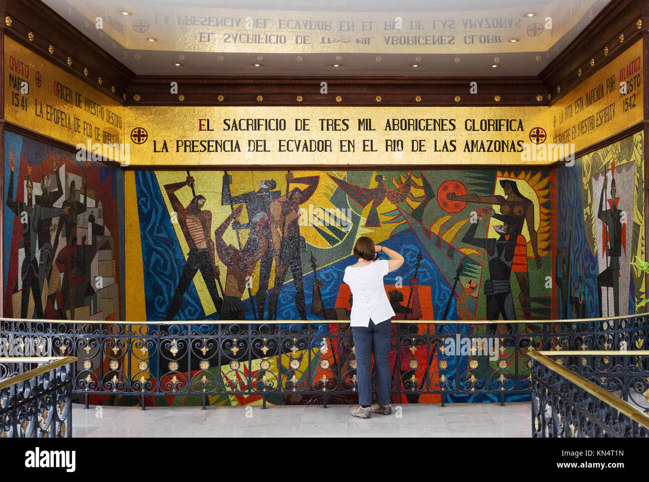 Tourist looking at the Mural of Discovery of Amazon by Oswaldo Guayasamin; Presidential Palace ( Carondelet Palace ), Quito, Ecuador South America Stock Photo
