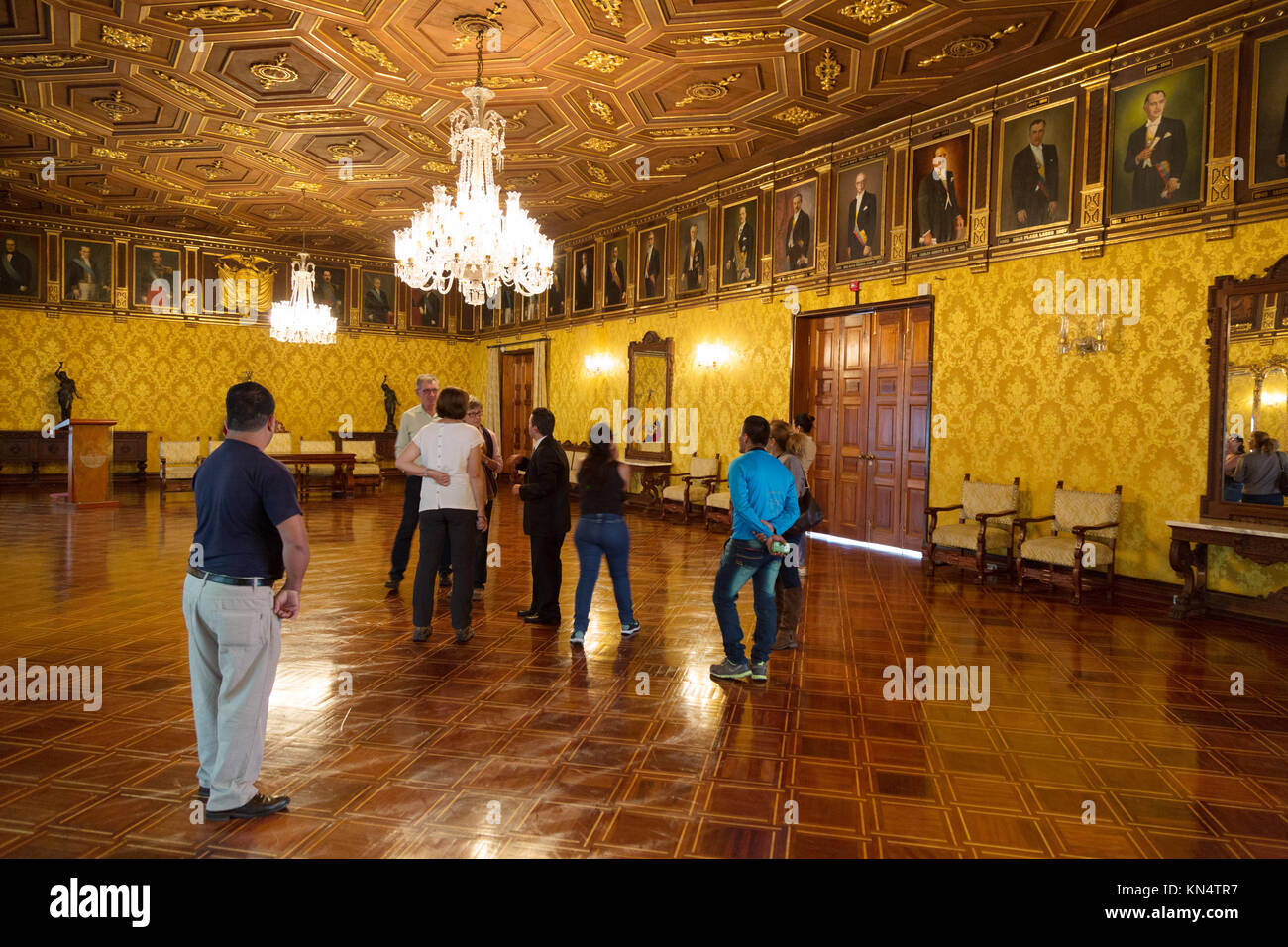 Presidential Palace, Quito, Ecuador interior- tourists on a guided tour in the Salon de los Presidentes; Quito, Ecuador, South America Stock Photo
