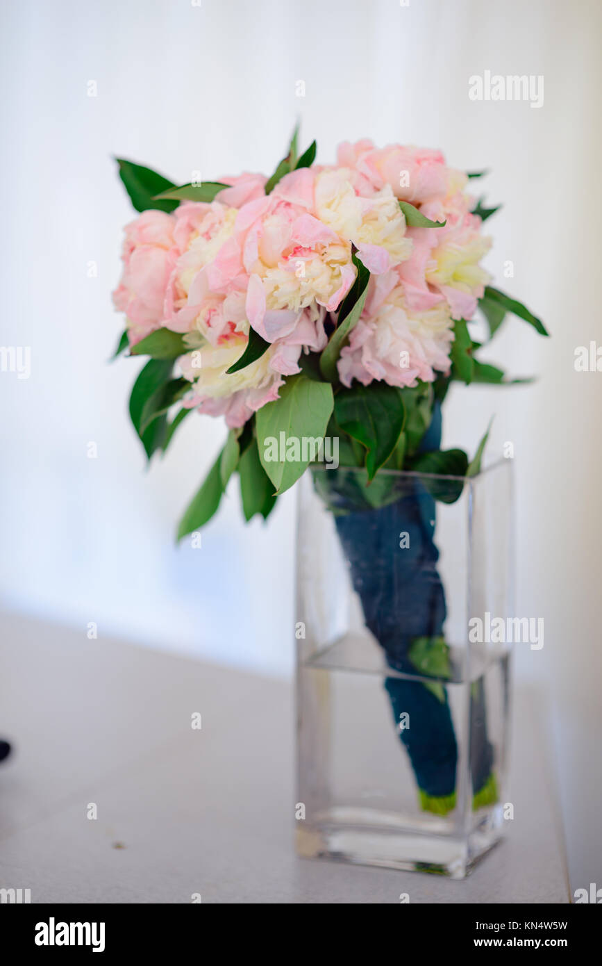 Floral composition with a peony and roses in a glass vase. Pink flowers ...