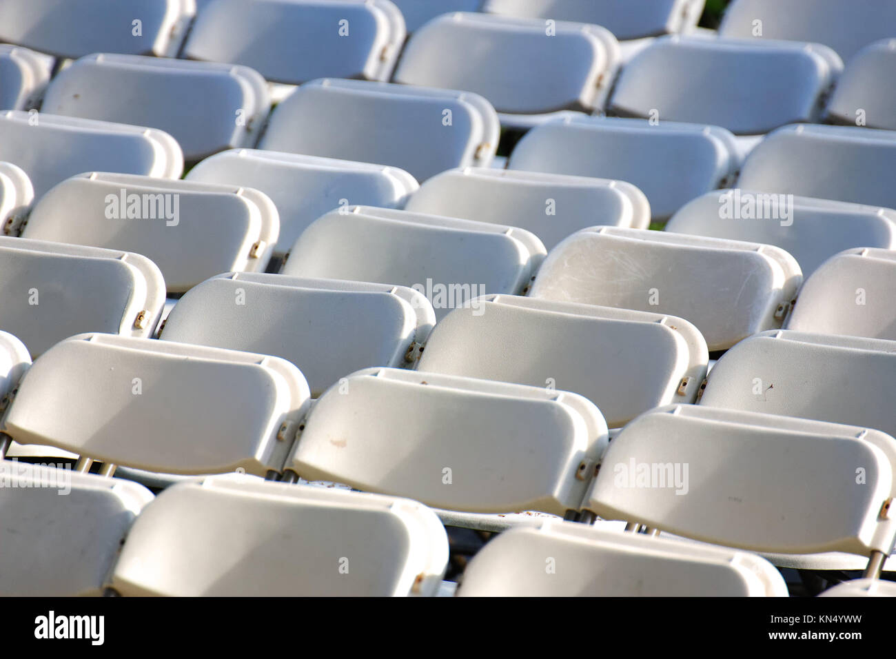 Row upon row of empty chairs waiting for the audience at a university graduation ceremony. Stock Photo