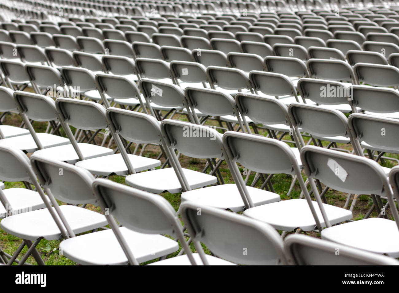 Row upon row of empty chairs waiting for the audience at a university graduation ceremony. Stock Photo