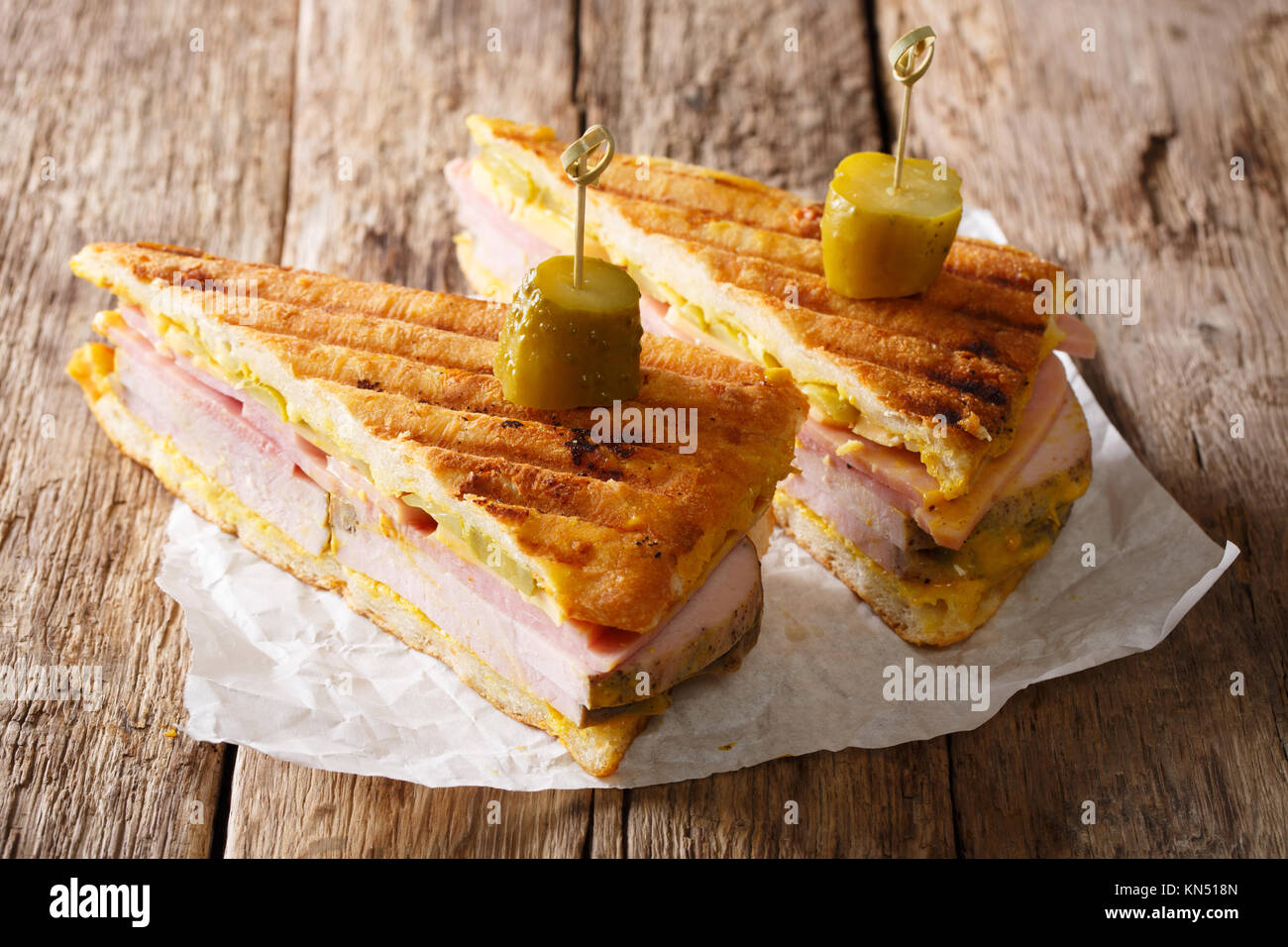 Cuban sandwich with ham, mustard, cheese, pickled cucumbers and pork