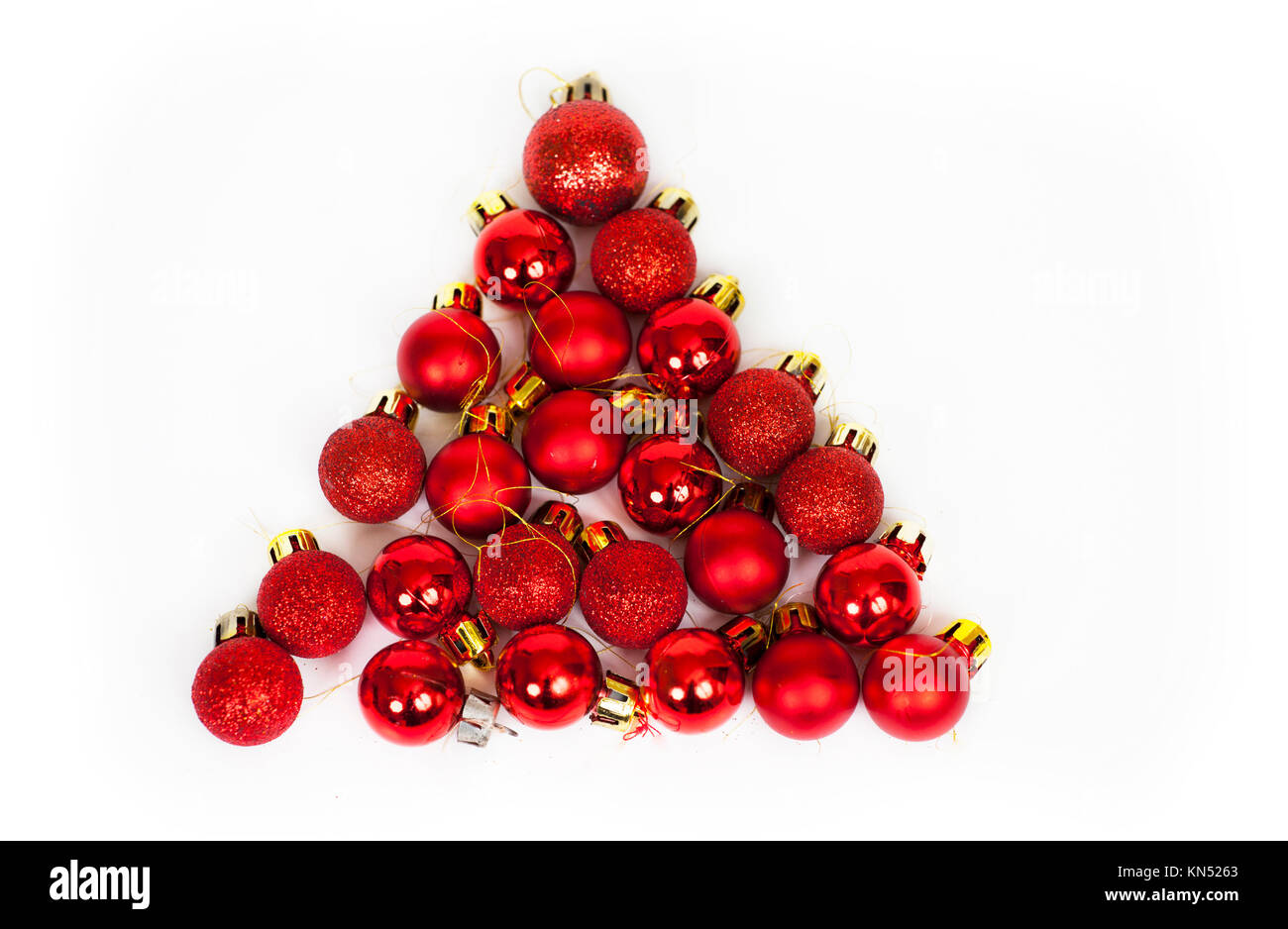 Christmas tree made from small red Christmas balls on white background