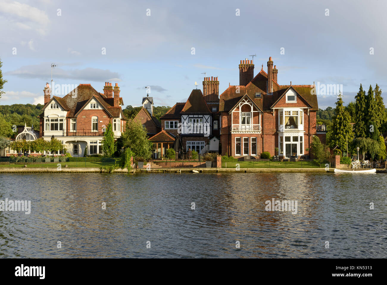 old houses and a white canoe over river Thames, Marlow, England, old