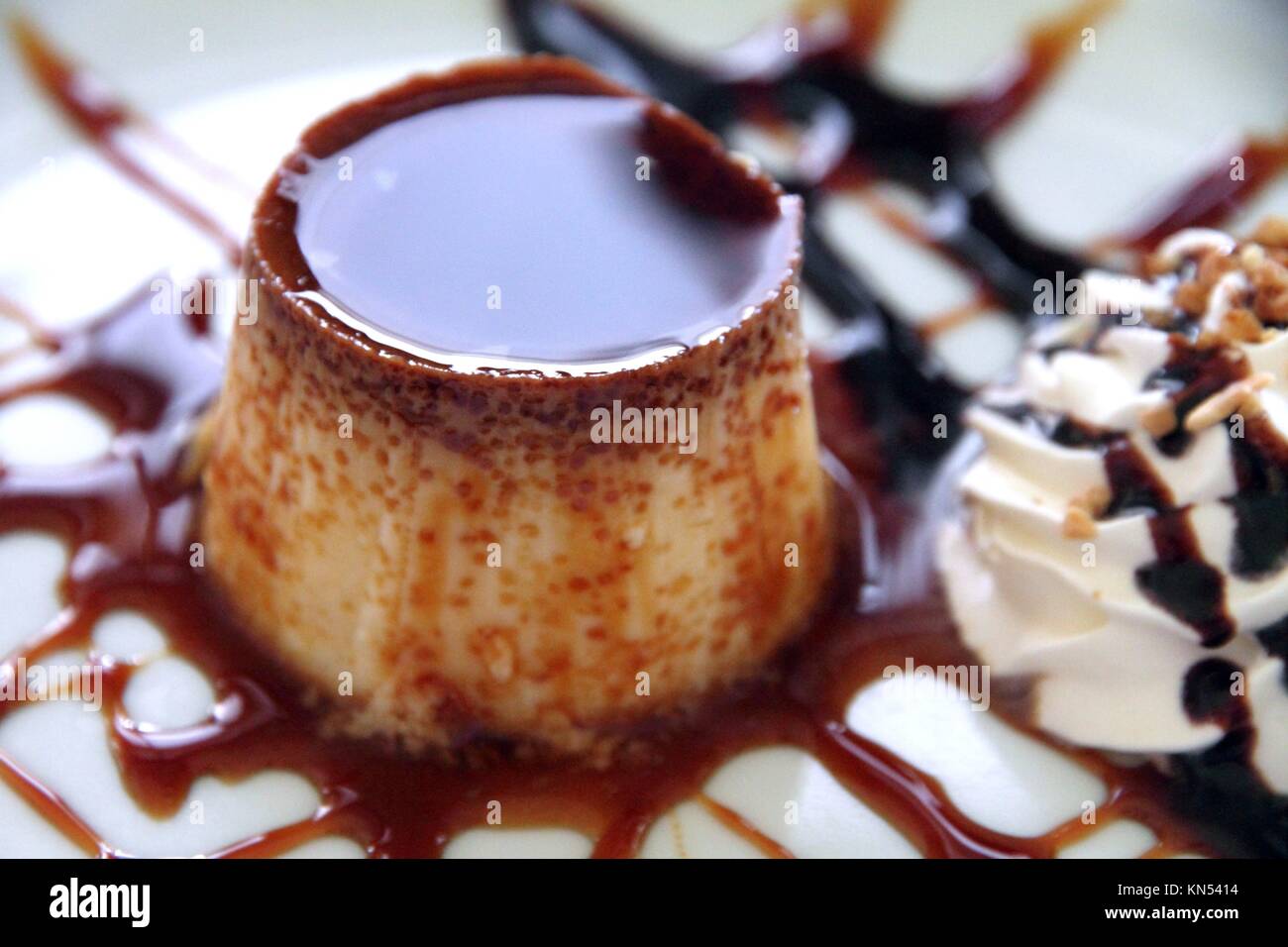 Flan caramel with cream on plate dessert Spain. Stock Photo