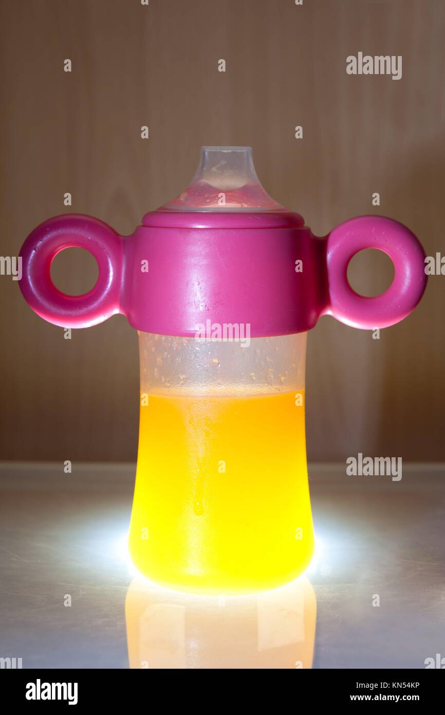 Baby bottle closeup full of orange juice Stock Photo Alamy