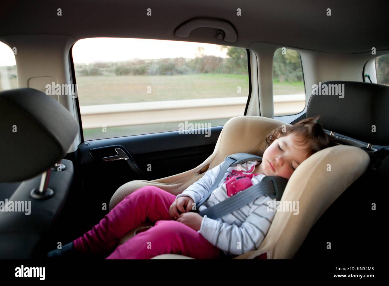 Baby girl sleeping in child car seat. Stock Photo
