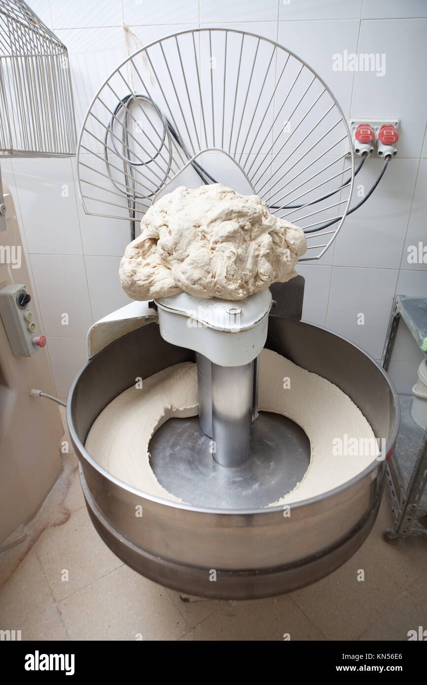 Food processor to kneading dough for bread. Manufacturing process of spanish bread. Stock Photo