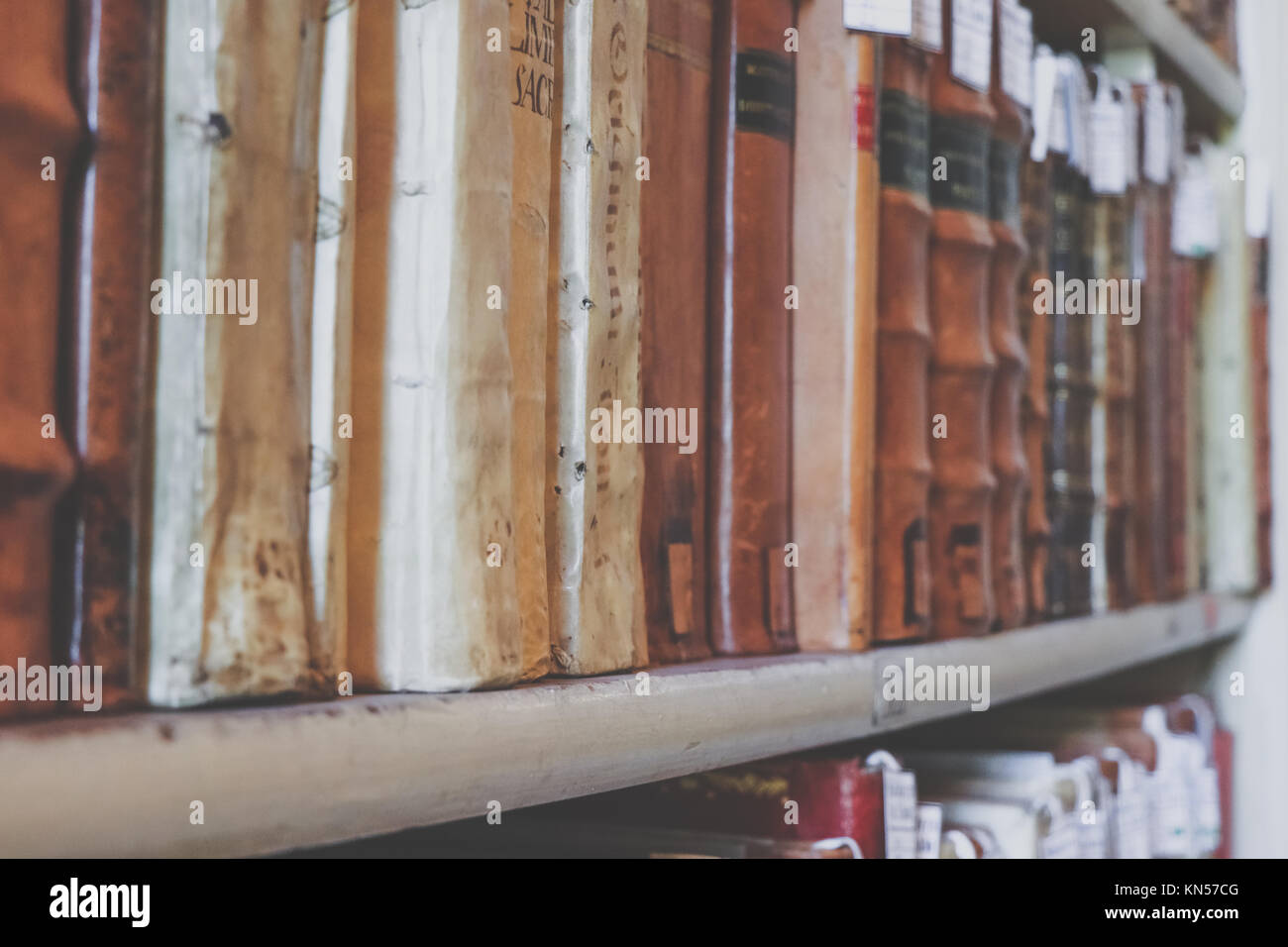 Old books on the shelves of a library Stock Photo - Alamy