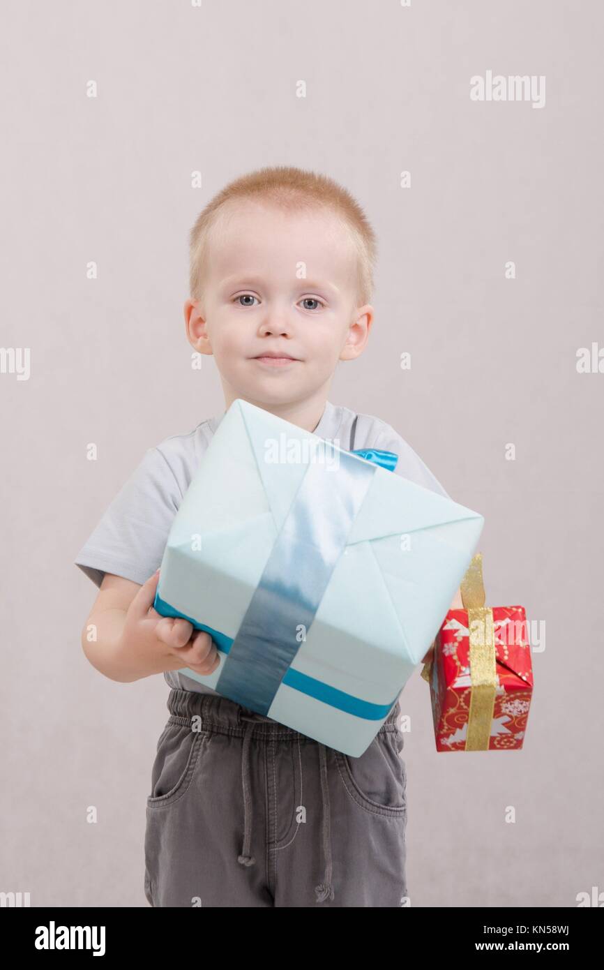 Portrait of a five year old boy with a gift in hands Stock Photo Alamy