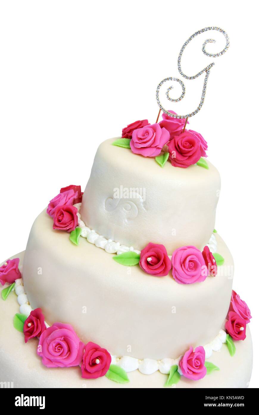 Three tiered wedding cake covered in marzipan and decorated with pink