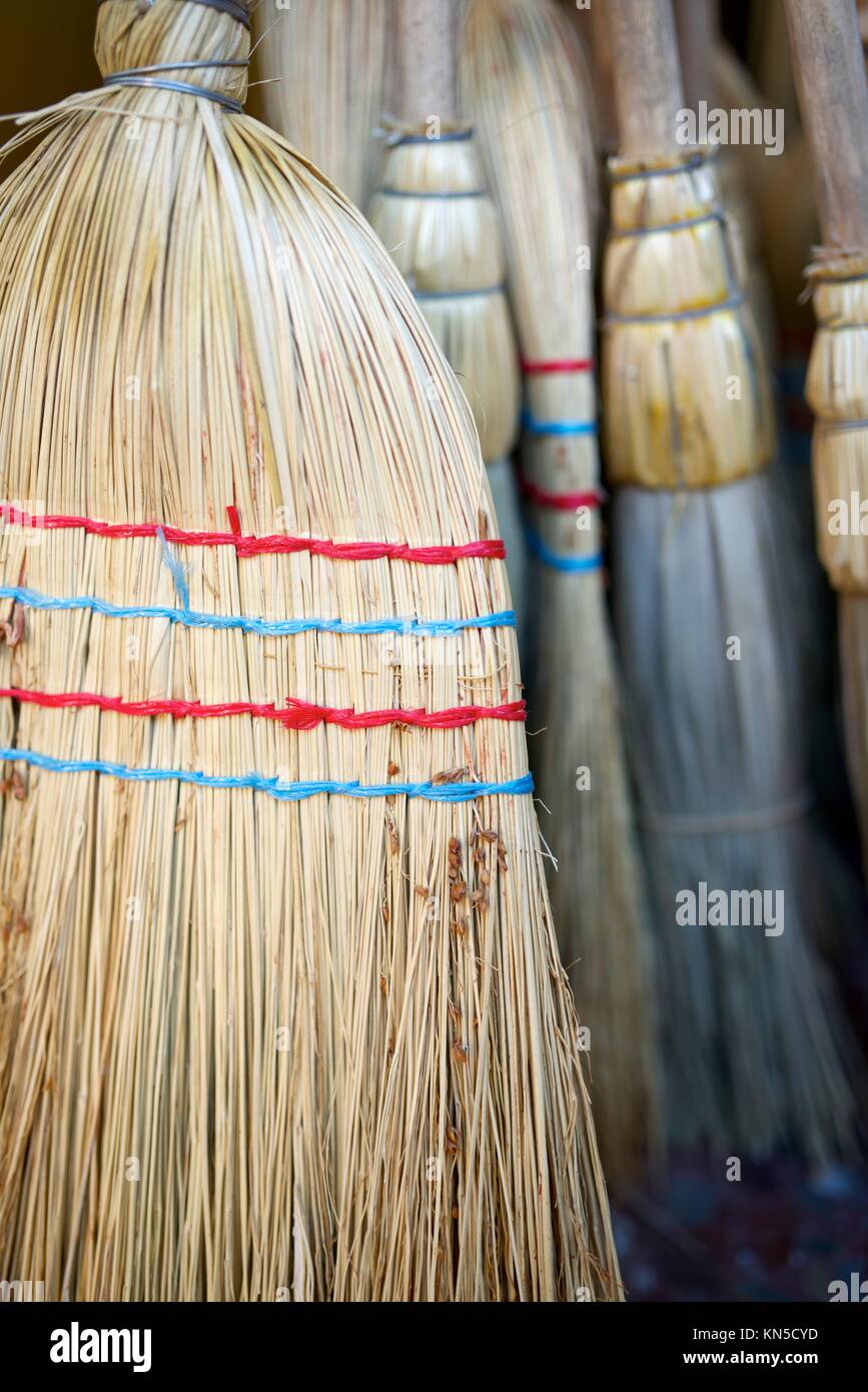 forefront of a group of straw brooms Stock Photo Alamy