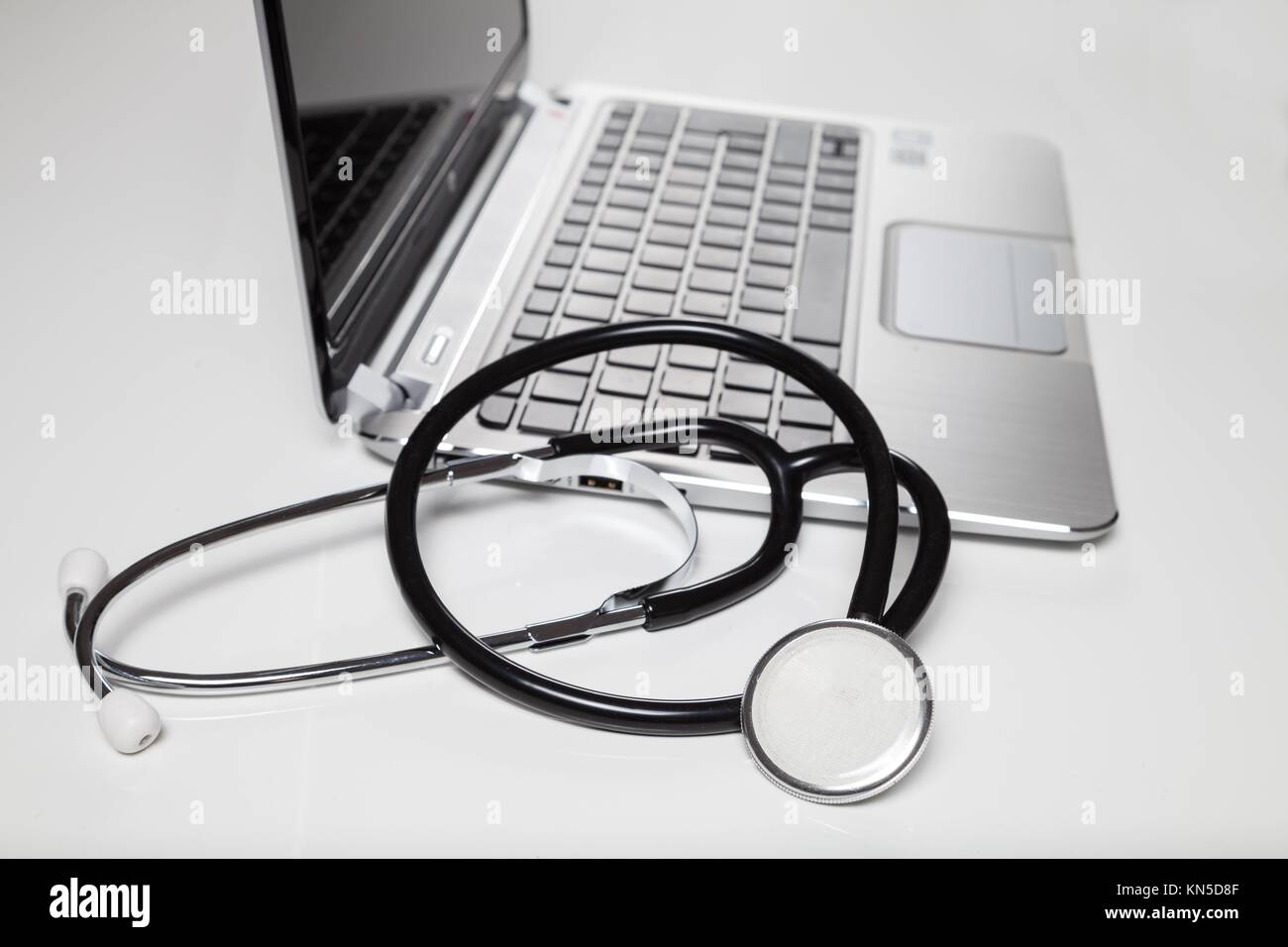 stethoscope and laptop on desk. Stock Photo