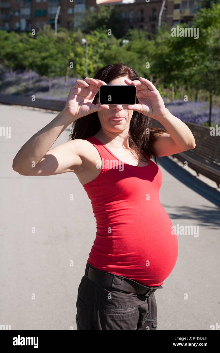 funny pregnant woman with smartphone in her hands Stock Photo Alamy