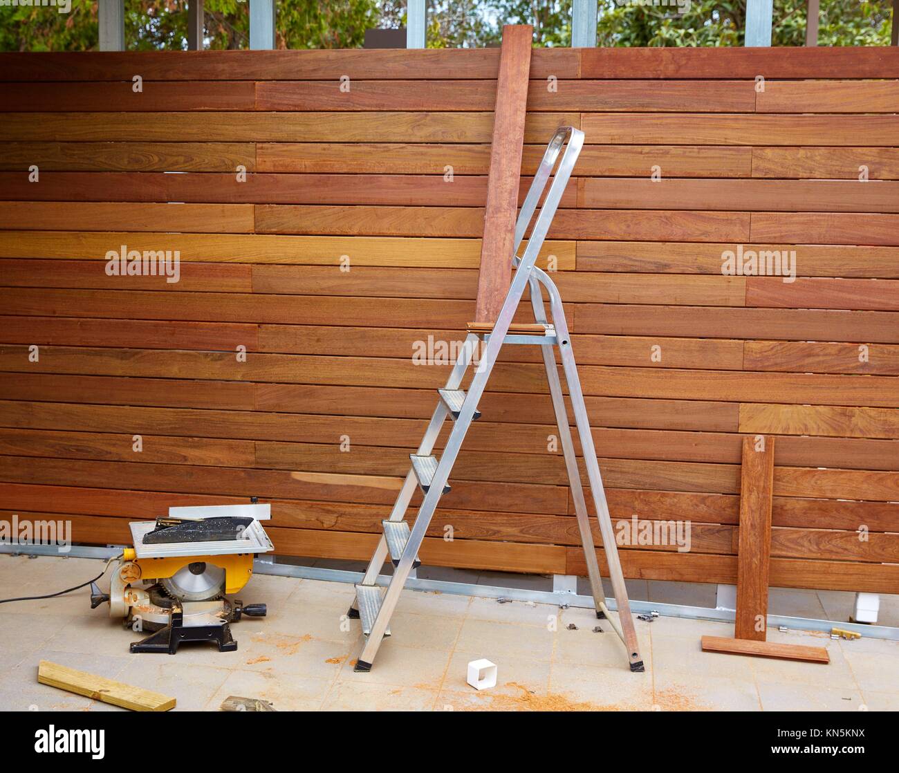 Ipe wood fence installation with carpenter table circular saw and