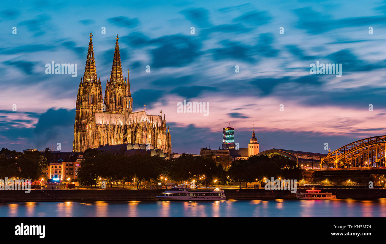 sunset sky with colors and clouds over the city skyline Cologne with ...