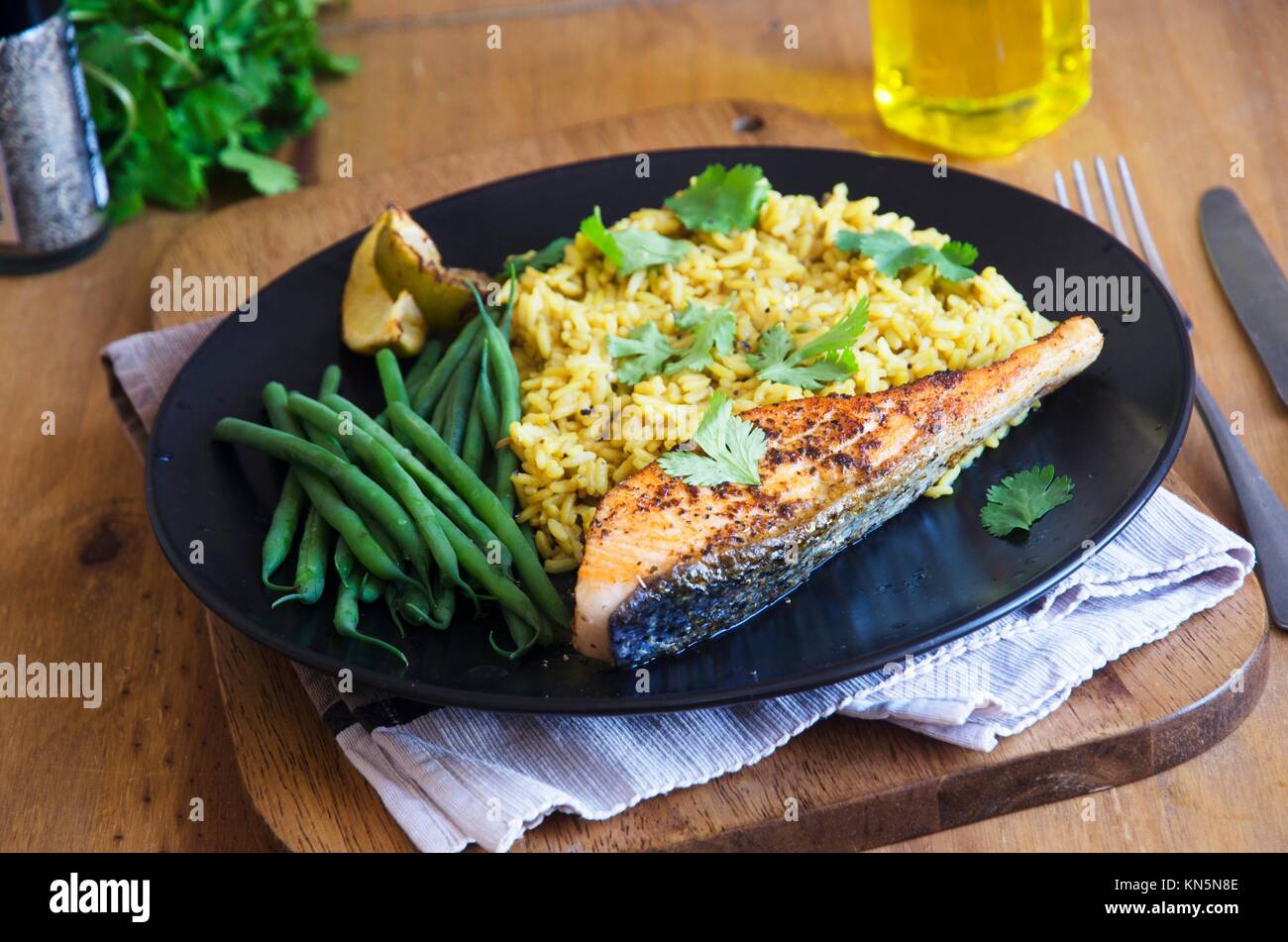 Cajunstyle salmon with pilau rice and green beans Stock Photo Alamy