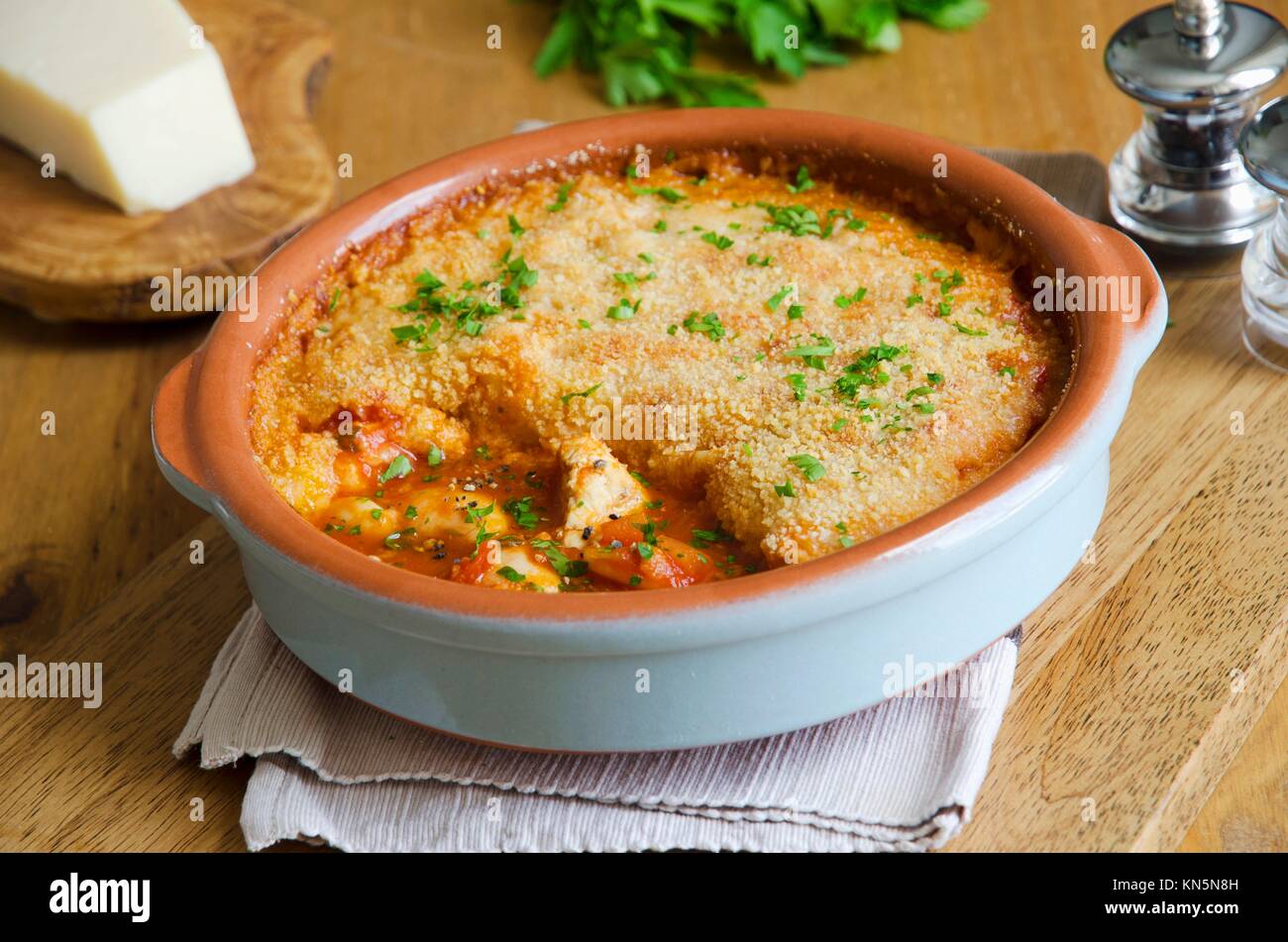 Chicken and butter bean cassoulet topped with grated Parmesan. Stock Photo