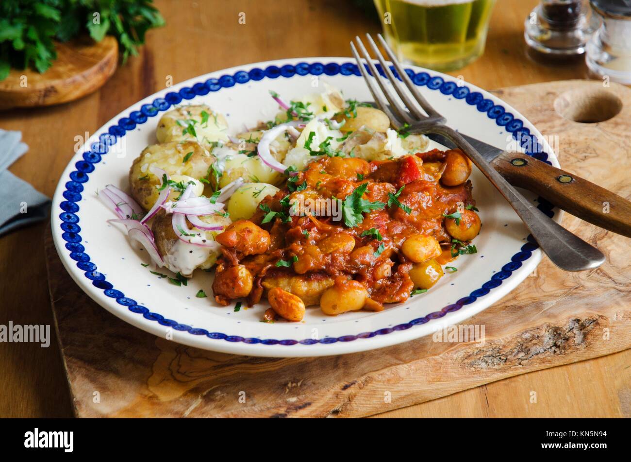 Chicken fillets with butter bean and yellow plum tomato sauce. Stock Photo