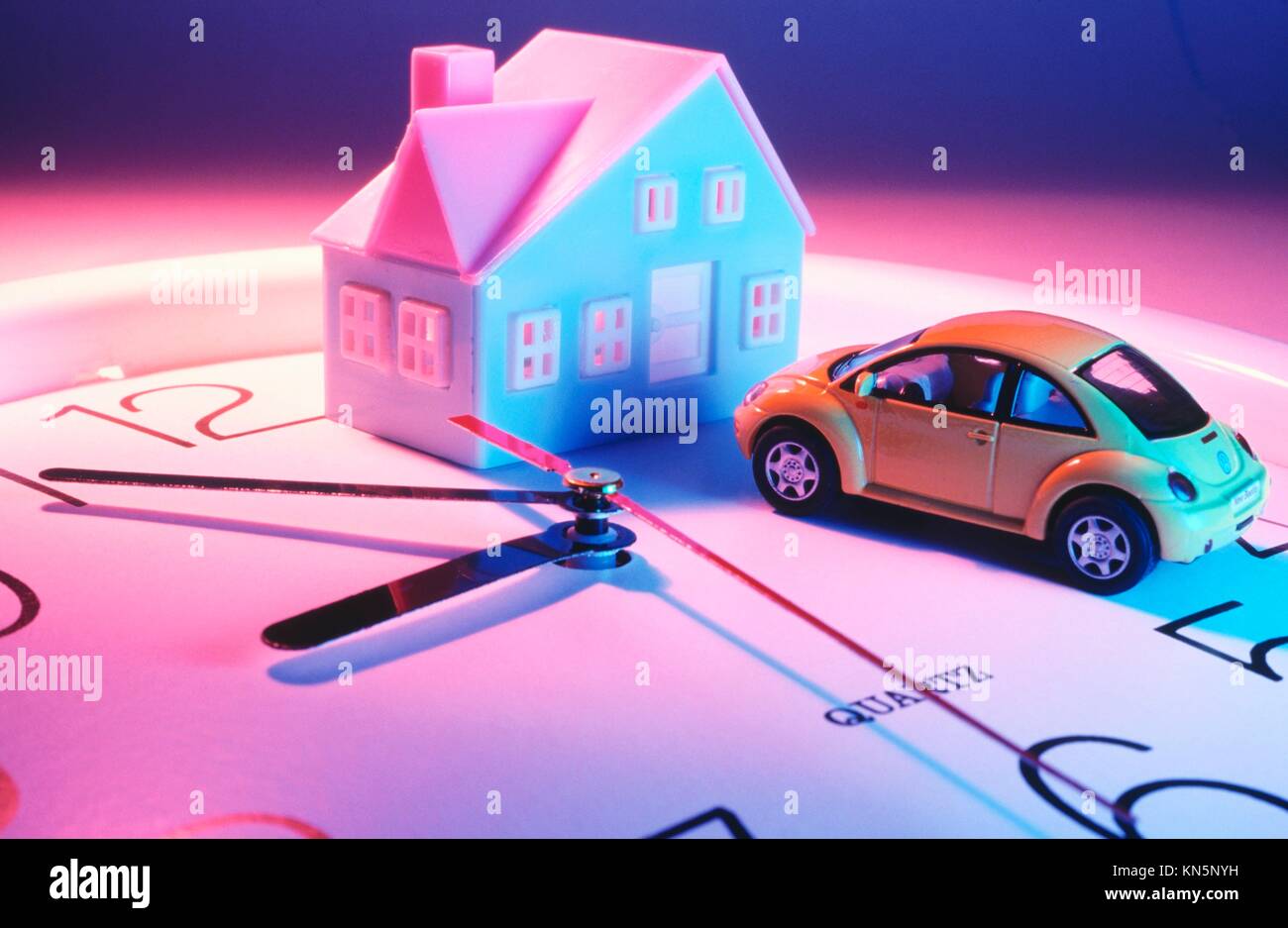 Toy house & car on clock Stock Photo Alamy