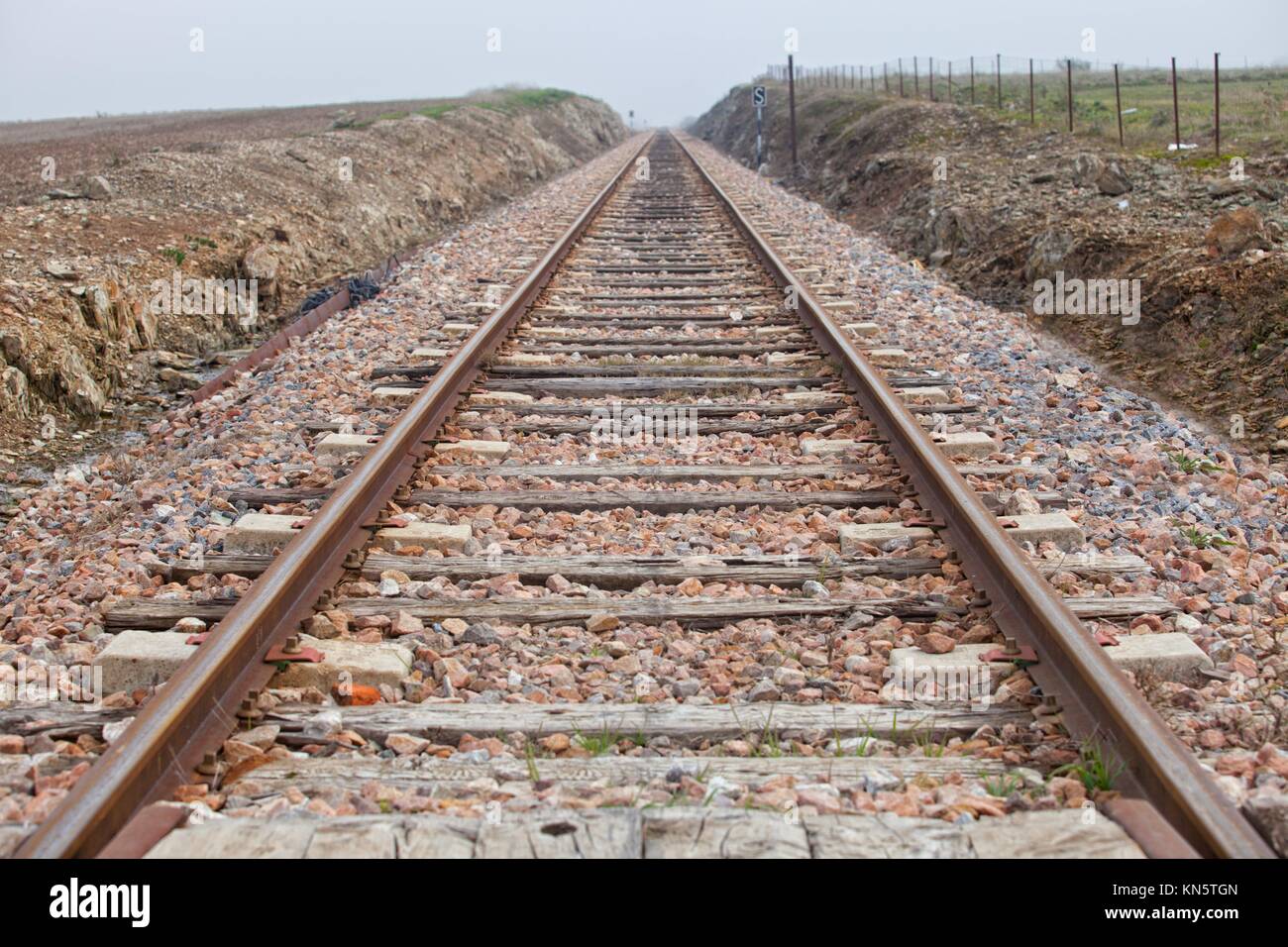 Railway tracks in a rural scene a dense foggy day, Badajoz, Spain. Stock Photo