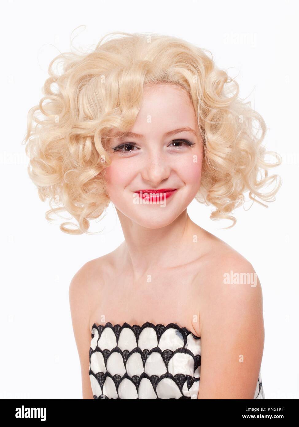 Portrait of a Young Girl with Blond Wig Posing as Marylin Monroe. Stock Photo