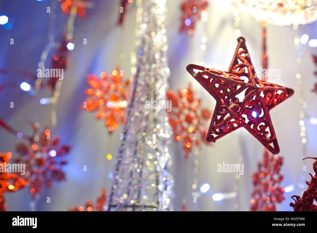 Red christmas star decoration hanging. Selective focus. Stock Photo