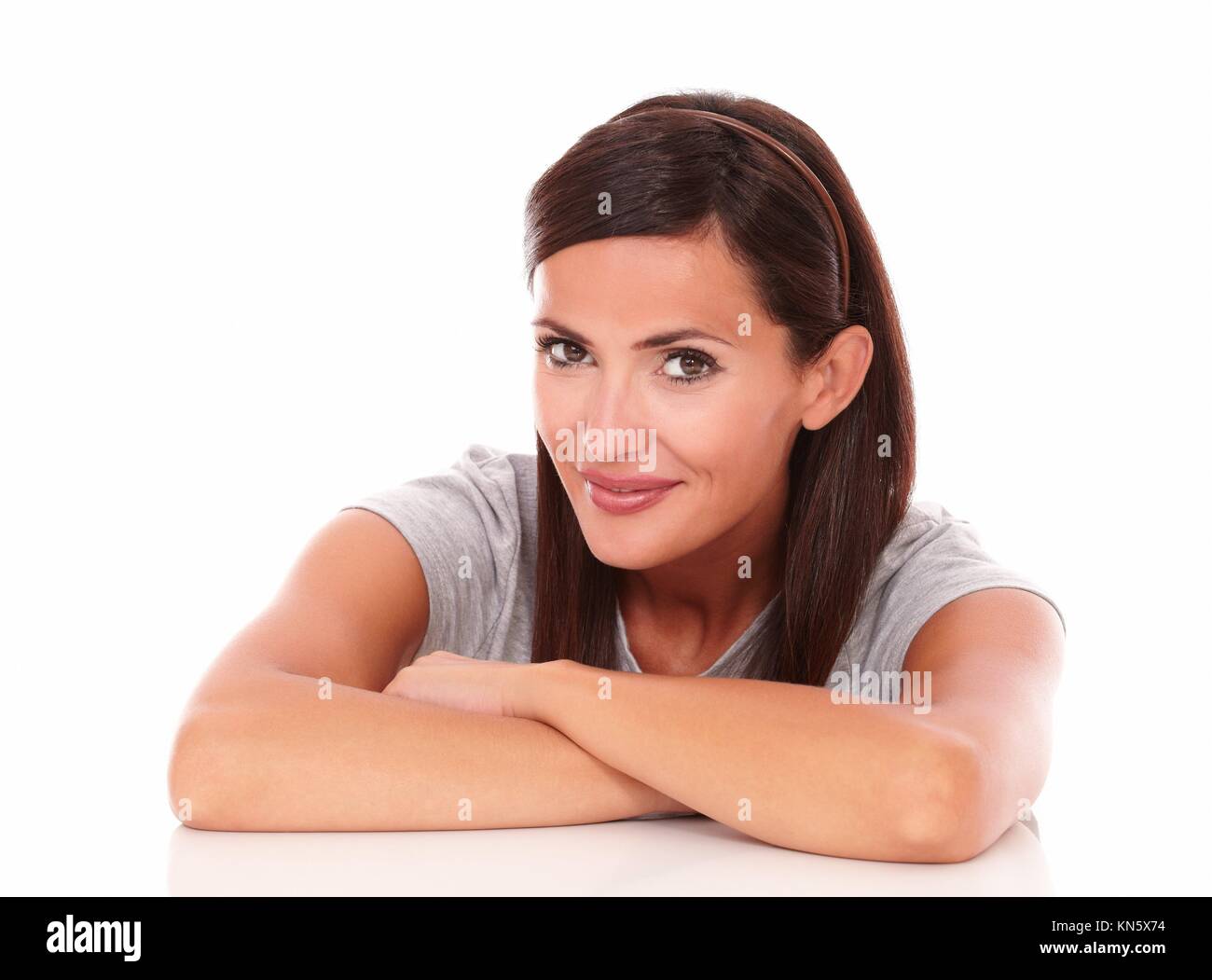 Head and shoulders portrait of lovely lady looking at camera and