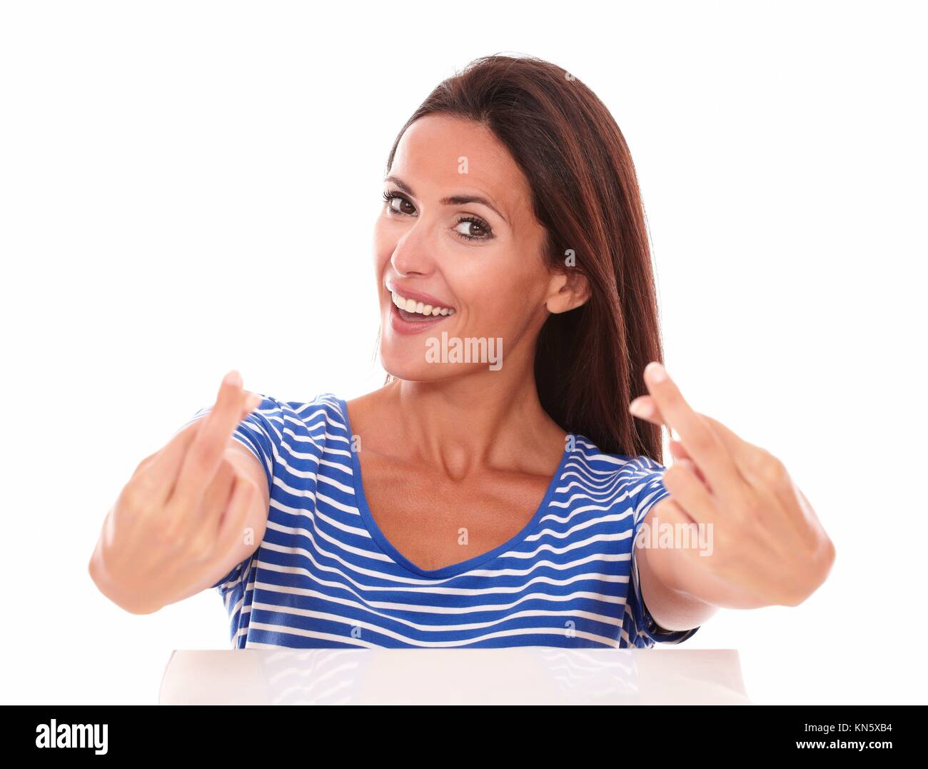Adult female making a wish sign while looking at camera in white background Stock Photo Alamy
