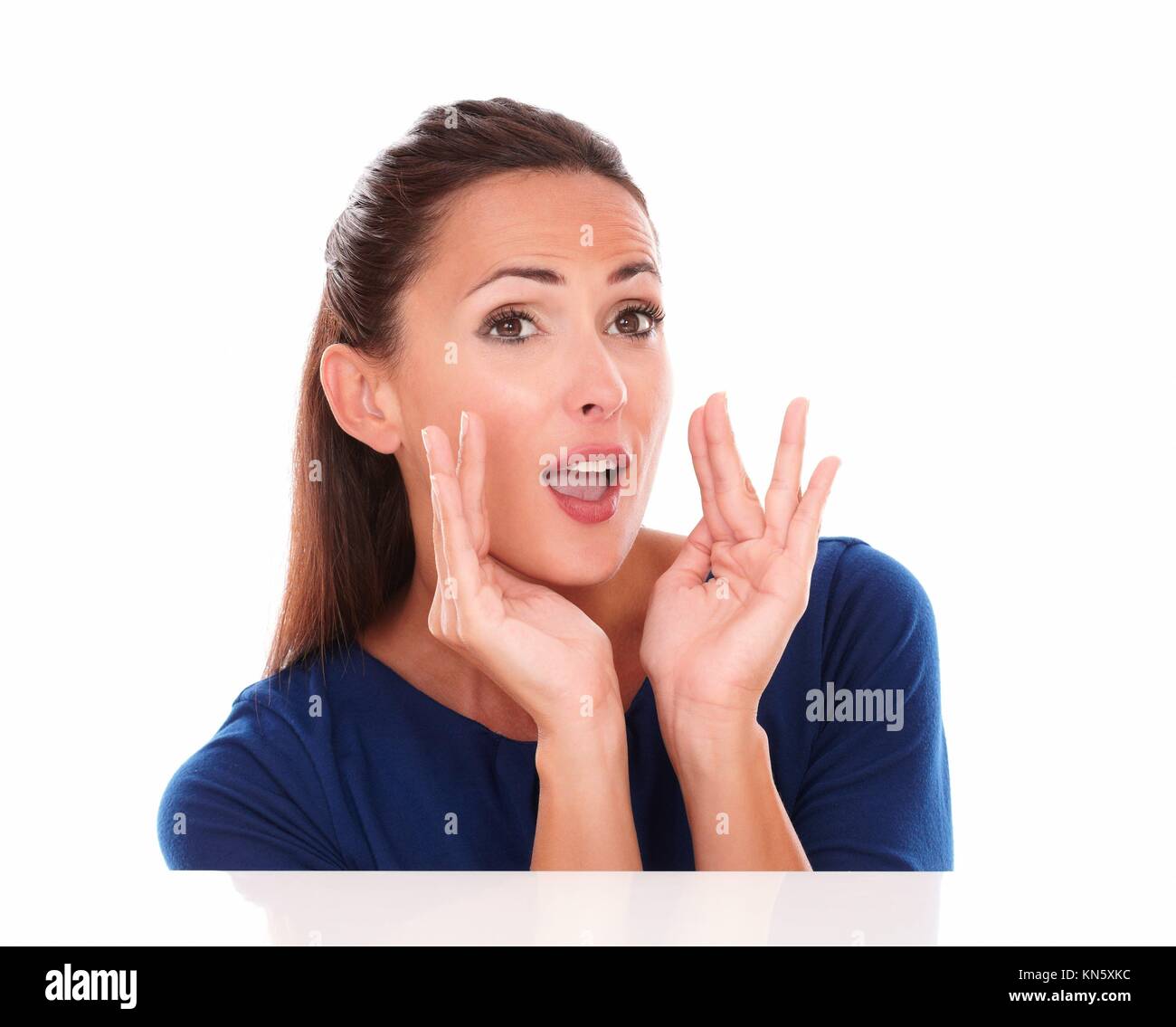 Cheerful lady in blue shirt gesturing screaming in white background - copyspace. Stock Photo