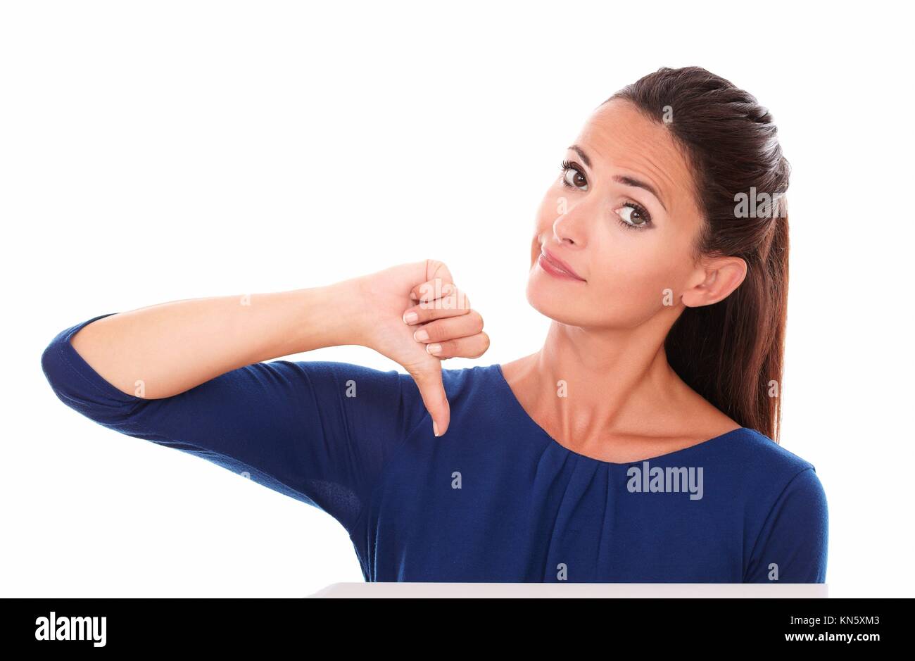Attractive adult in blue shirt with thumb down, gesturing bad job ...